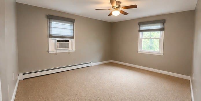 Bedroom repainted a soft warm grey with white trim
