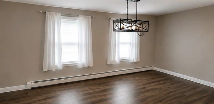 Dining room in warm grey with a black lantern chandelier