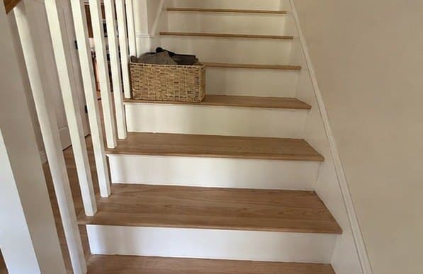 Stairwell painted a clean off white with white risers and balusters